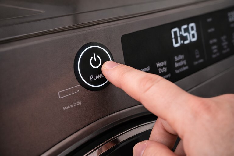 Dryer repair service technician working on appliance